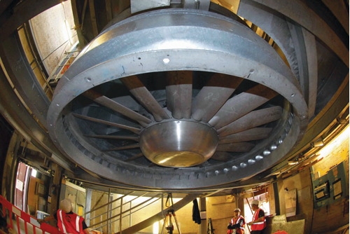 A huge, overhead extraction axial fan being installed in a service shaft on London Undergrounds Victoria line