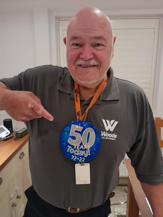 A man wearing a 50 years badge